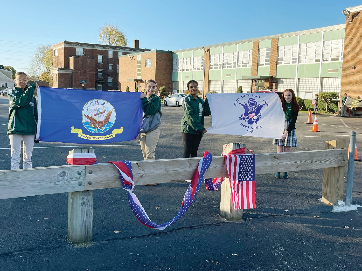 On November 10, students from Saint Teresa School in Pawtucket paid special tribute to the American veterans who have so heroically defended and served the country. Middle school students formed an honor guard to greet each student and parent as they arrived at school this morning. For the rest of the day students made ornaments for a veterans’ group and for the month of November the school community will collect warm clothing and food for veterans.